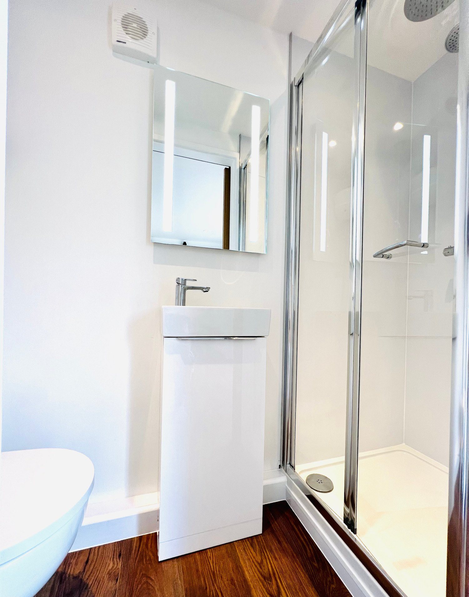 20ft Container Home – One Bed Box, 1 Bedroom – The space-saving bathroom layout features a modern vanity and glass walk-in shower within a 20ft container conversion