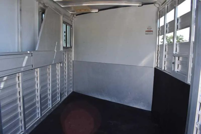 2014 Sundowner 2 Horse Gooseneck Trailer – Electric Jack – Wide angle interior view of the horse transport section with metal walls