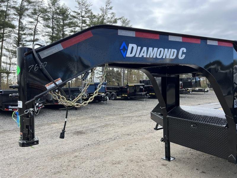 2024 Diamond C 35 ft Equipment Trailer – Auto Dovetail – Close-up of the black gooseneck coupler and safety chains