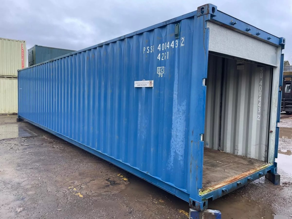 40ft Used Shipping Container – Roll-Up Door, Power & Lighting – three-quarter exterior view of blue container with open roll-up door