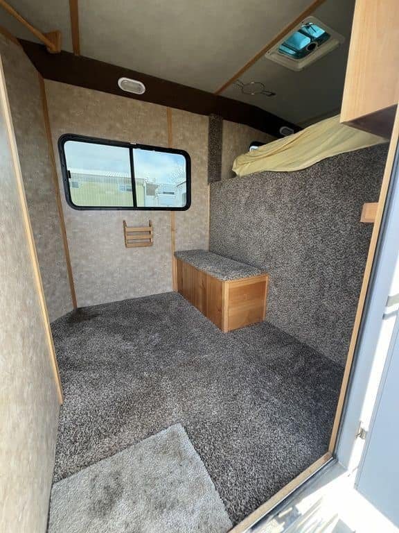 2020 Trails West Sierra 4 Horse Gooseneck – Comfort Package – Floor level view of the carpeted dressing room with storage bench