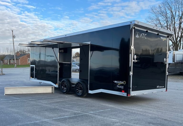 2026 ATC 24 ft Car Hauler – Black, Plus Package – Rear three-quarter view of a black enclosed trailer with a large escape door open