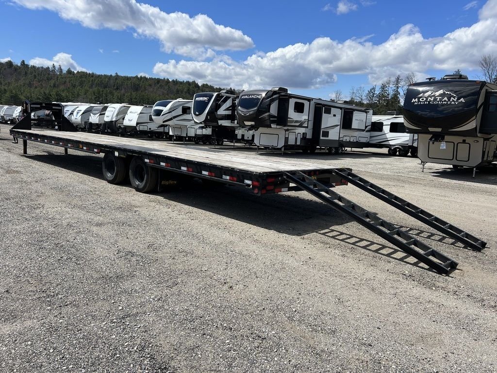 2023 Big Tex 40 ft Equipment Trailer – Slide-Out Ramps – Three-quarter rear view of the flatbed trailer with ramps deployed on gravel