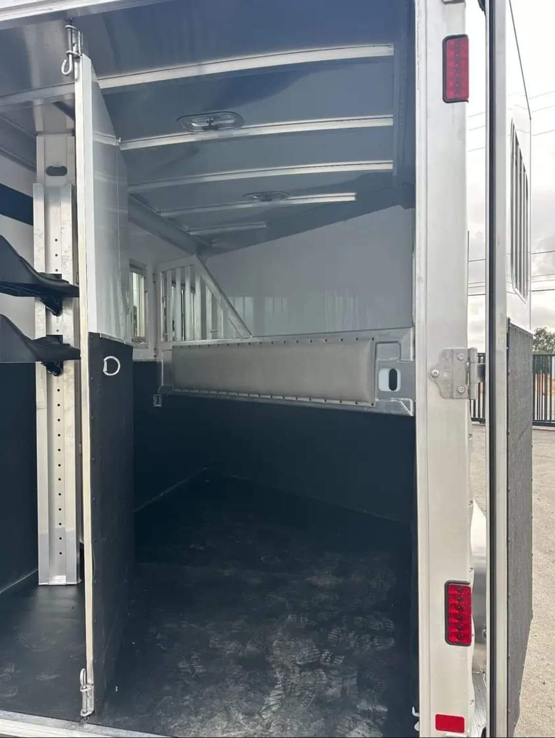 2012 Featherlite 9400 2 Horse Trailer – Removable Tack – View through the rear door showing the internal divider and floor mat