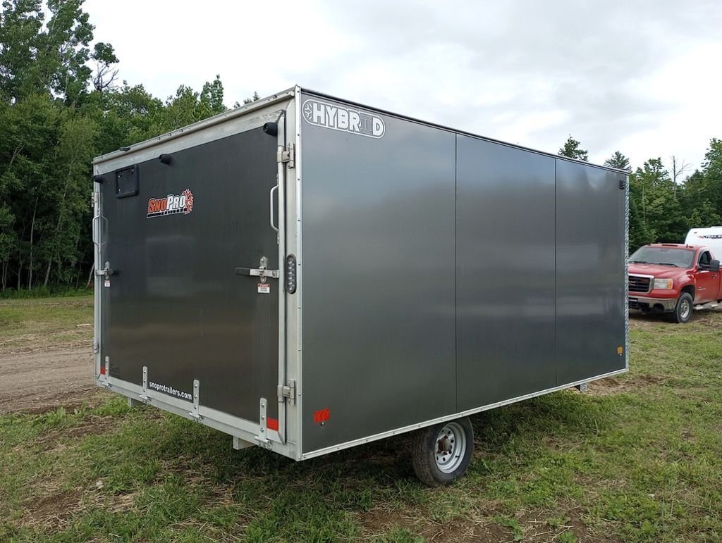 2022 Sno Pro Trailers Hybrid 2.0 – Charcoal Snowmobile Trailer – Rear three-quarter view from the passenger side showing the closed ramp door