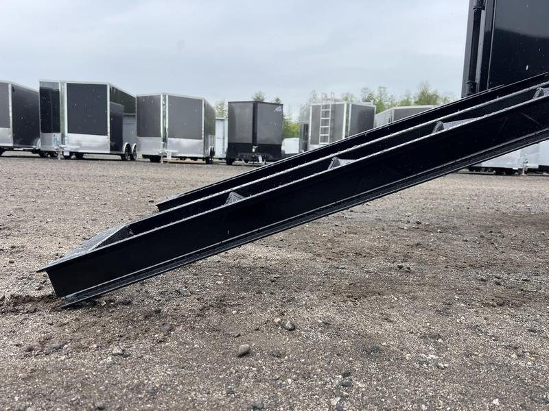 2024 RawMaxx 16 ft Dump Trailer – Tarp Kit – Close-up of a black metal pull-out ramp extending to the ground