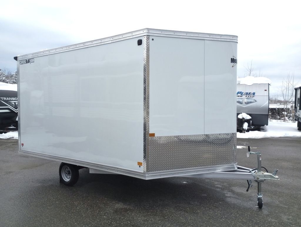 2024 Mission Trailers 12 ft Powersports – Side X Side – A three-quarter exterior view of a white enclosed trailer with a silver diamond plate front