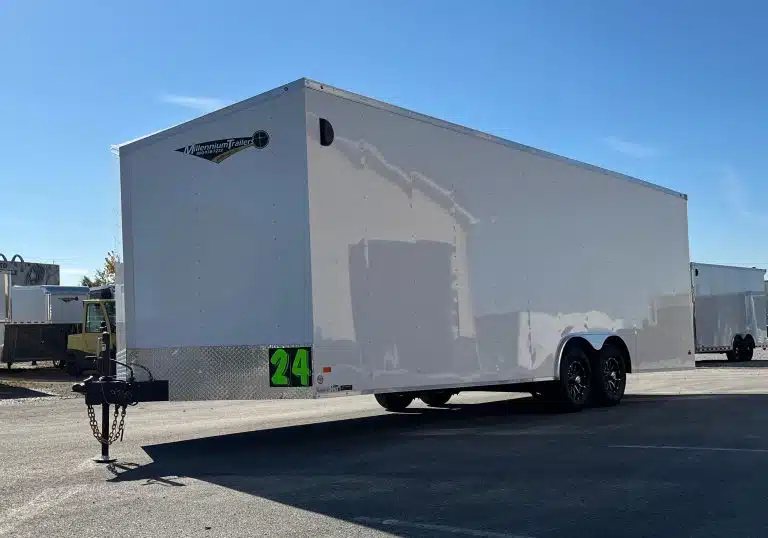2026 Millennium 24 ft Car Hauler – White Hero – Front three-quarter view of a white enclosed car hauler trailer against clear blue sky