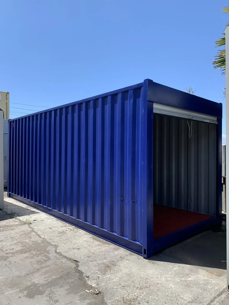 30ft Modified Storage Container – Roll-Up Access – three-quarter exterior view of blue container with roll-up door open