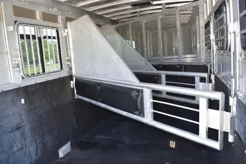 2006 Adam 7302 3 Horse Trailer – Aluminum, Dressing Room – Horse trailer interior stall area with a divider partially swung open