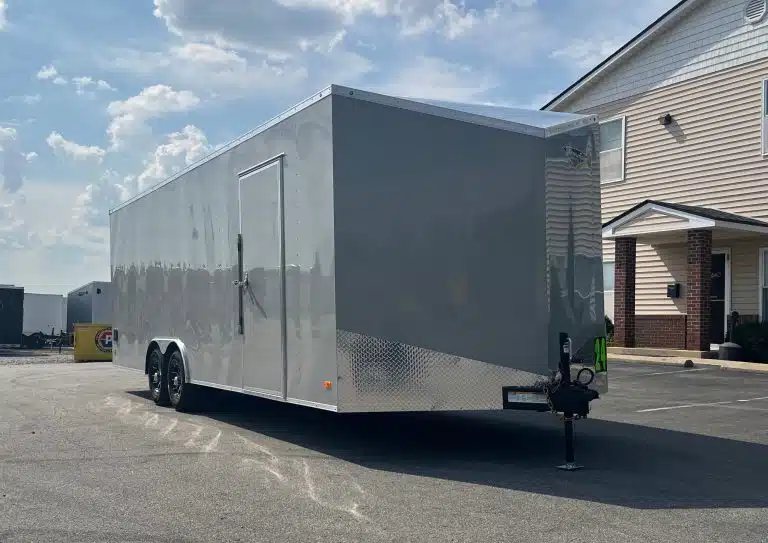 2026 Millennium Hero 24 ft Car Hauler – Gray Dove – Left side exterior view of the silver car hauler showing the side entry door