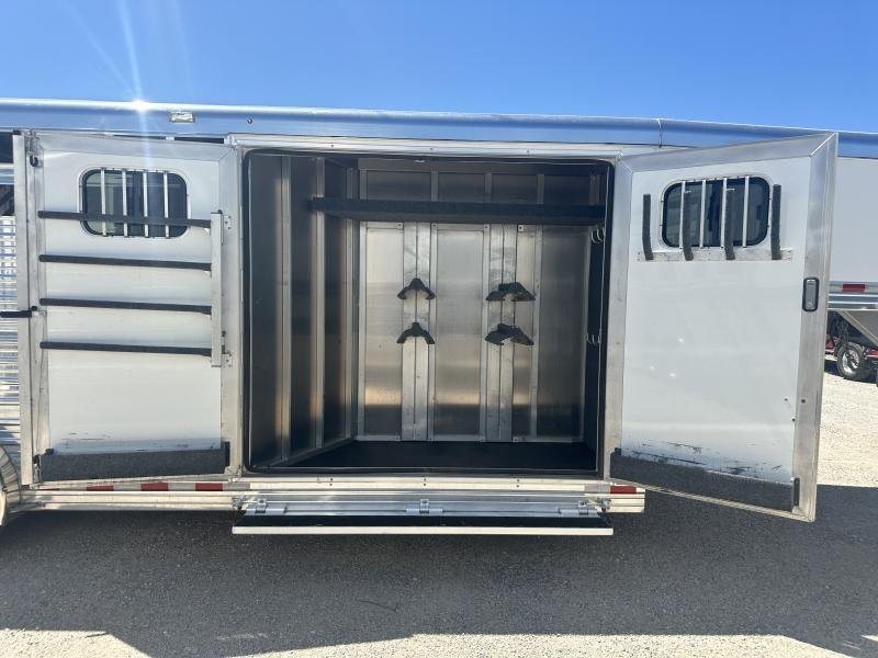 2020 Bloomer 4 Horse Stock Combo – Trainer Tack – Open rear tack room doors showing saddle racks and bridle hooks