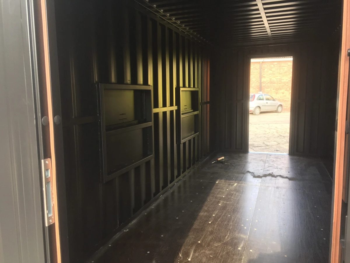 20ft Converted Shipping Container – Serving Hatches and Roof Deck – empty container interior with folded wall panels and open doorway