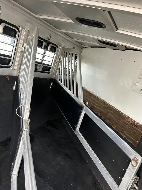 2002 Silverado 3 Horse Gooseneck Trailer – Wood Interior – Angled view of the horse stalls showing the padding on the lower dividers