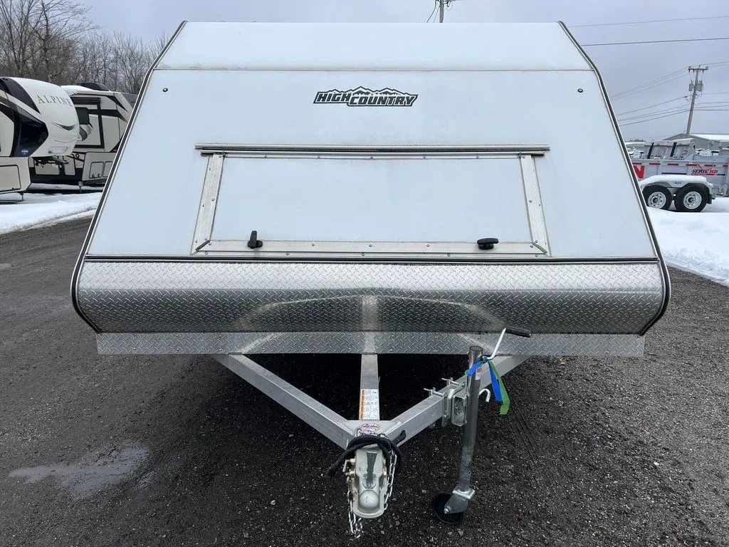 2022 High Country 12 ft Hybrid Trailer – Track Mats – Front straight-on view of the trailer showing the diamond plate stone guard