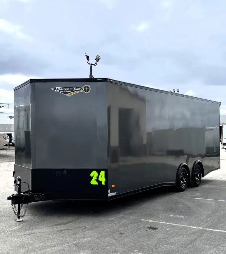 2025 Millennium 24 ft Car Hauler – Charcoal – Exterior three-quarter front view of a grey enclosed car hauler with black trim