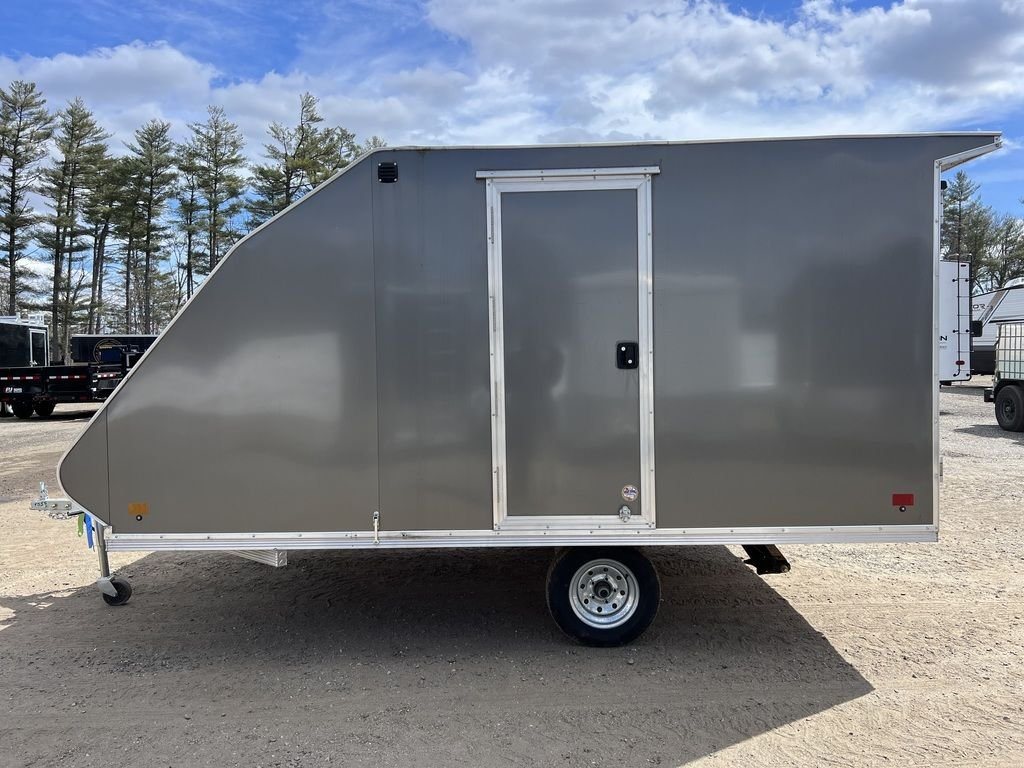 2023 Sno Pro 2-Place Snowmobile Trailer – Galvanized Package – Profile view of the grey aluminum trailer featuring a side access door