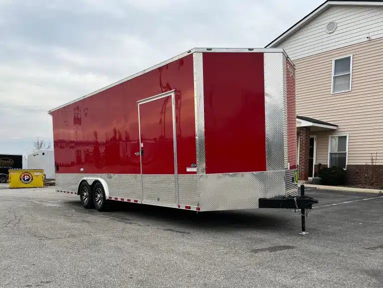 2026 Millennium 24 ft Car Hauler – Red, Econo-Max – Full side profile of the red trailer parked next to a building