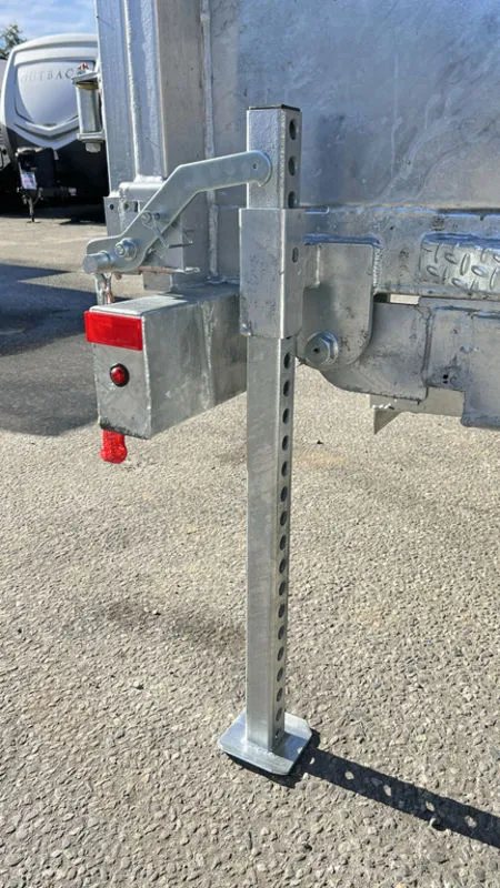 2024 N&N Trailers 14 ft Dump – Galvanized Steel – Close-up of the rear stabilizer leg in the extended down position