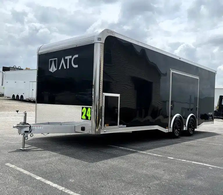 2026 ATC 24 ft Car Hauler – ROM 450, LifeTrac – Three-quarter front view of a black enclosed car trailer with aluminum trim