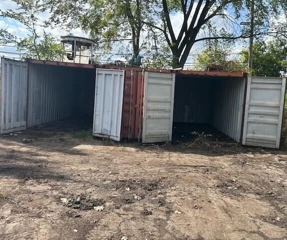 20ft Used Shipping Container – Double Cargo Doors – two weathered shipping containers with cargo doors open