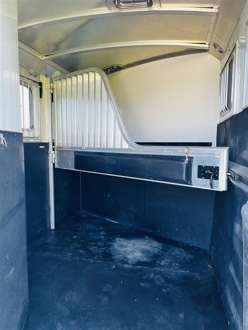 2015 4 Star 2 Horse Bumper Pull – Slant Load, Rear Tack – Interior horse stall area with rubber floor mats and an aluminum divider