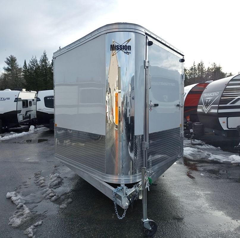 2024 Mission Trailers 24 ft Deckover – Galvanized Package – Close-up of the chrome V-nose front and hitch assembly of the trailer
