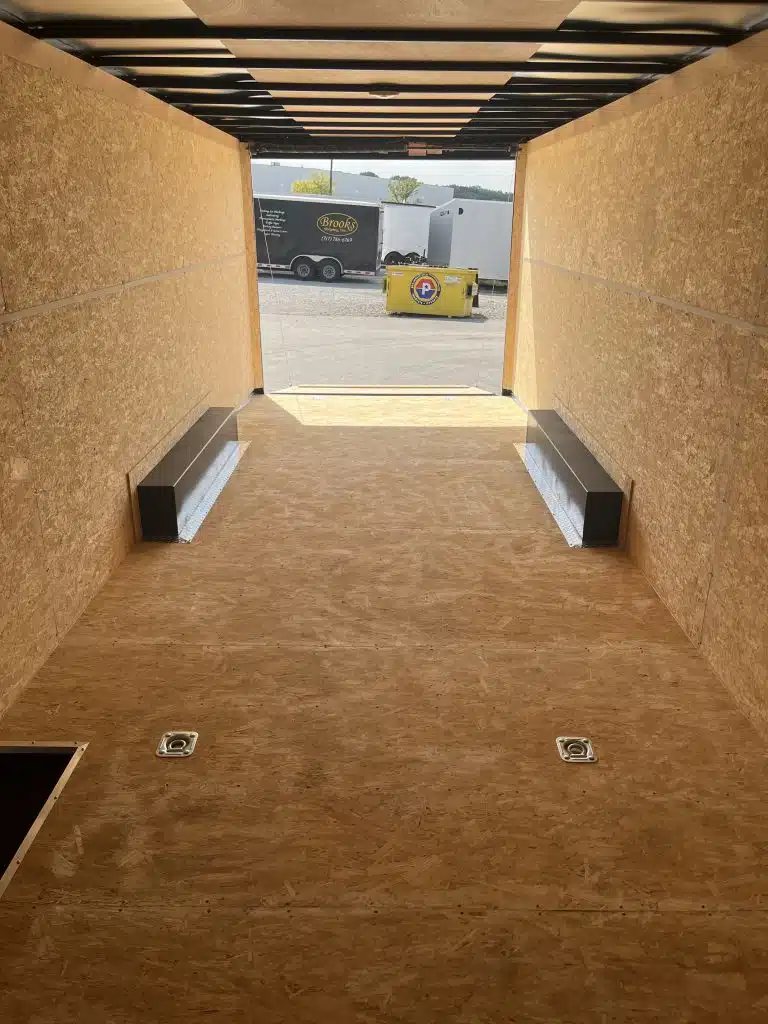 2026 Millennium Hero 24 ft Car Hauler – Gray Dove – Interior view looking towards the open rear ramp door and recessed tie-down rings