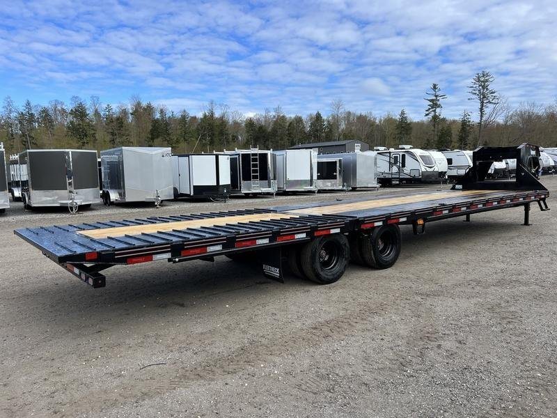 2024 Diamond C 35 ft Equipment Trailer – Auto Dovetail – Rear three-quarter view of the black trailer parked on a gravel lot
