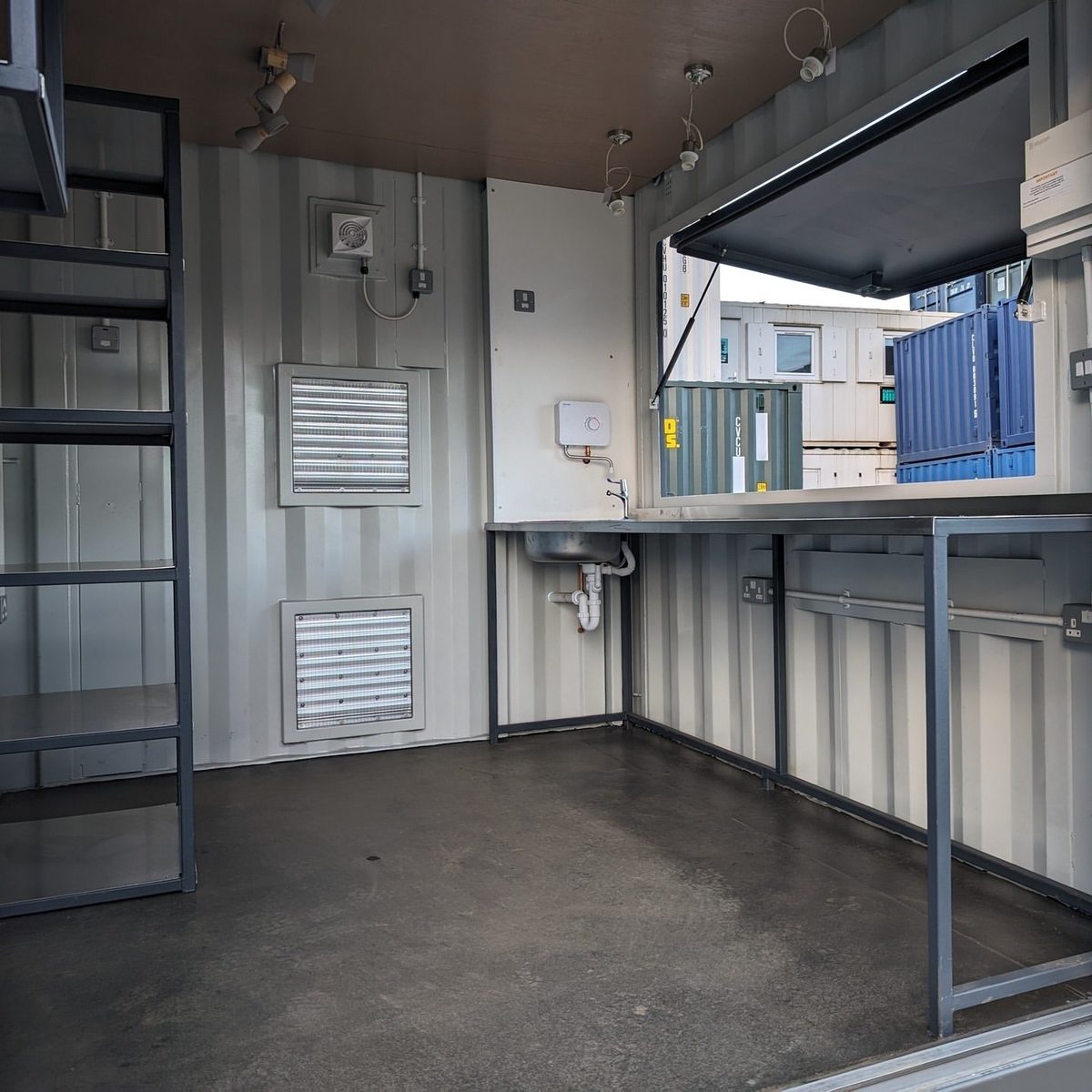 10ft Custom Pop-Up Bar Container – Full-Width Serving Hatch – empty bar interior with serving hatch, sink and metal shelving