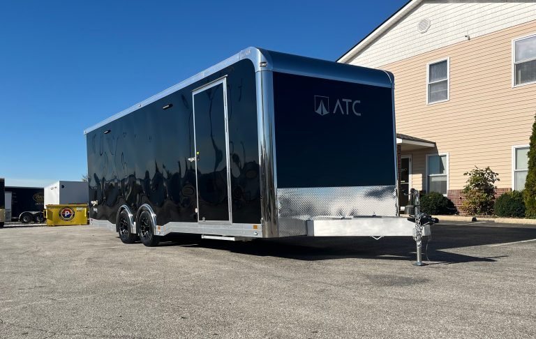 2026 ATC 24 ft ROM 550 Trailer – Black, Lithium – Curbside exterior view of a black trailer with a side entry door and chrome trim