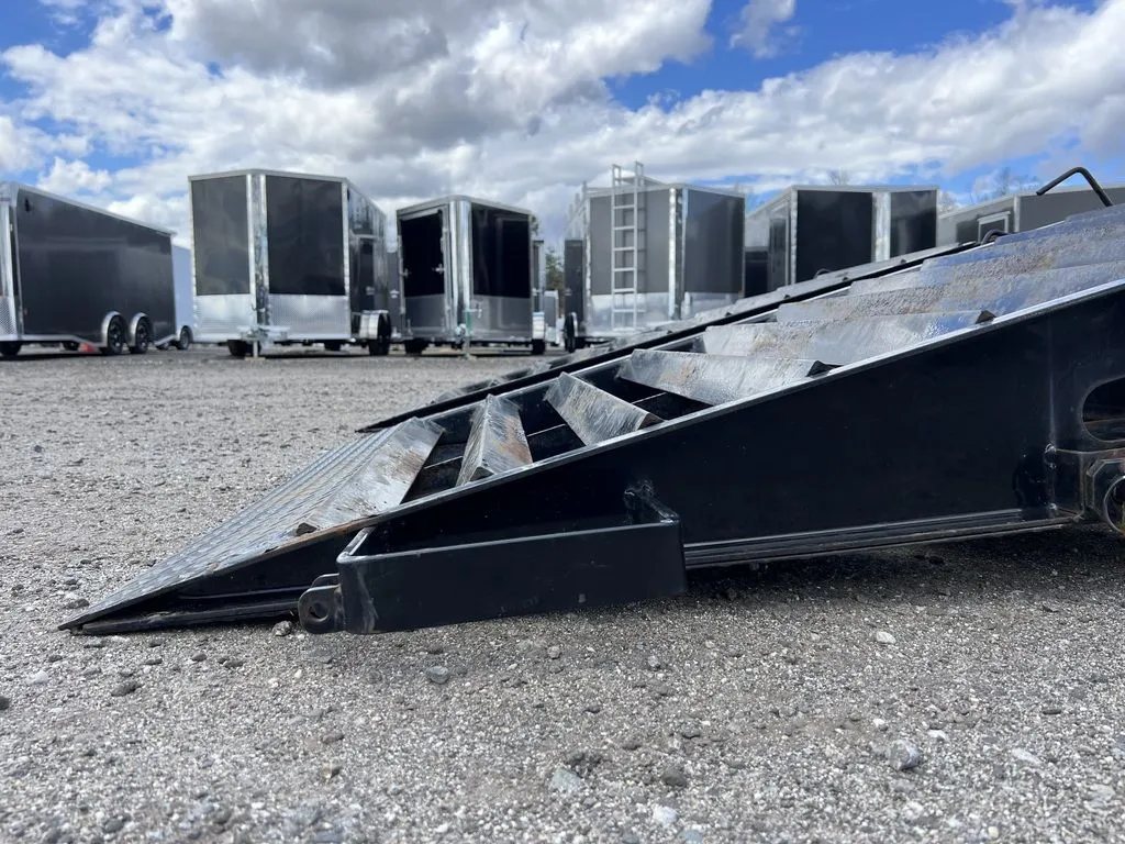 2022 Iron Bull Trailers Equipment Trailer – Rampage Ramps – Low angle side view of the heavy duty metal loading ramp touching the ground