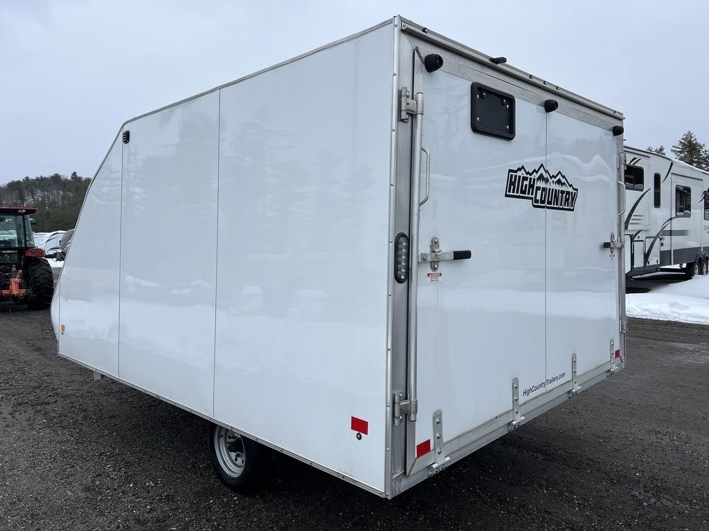 2022 High Country 12 ft Hybrid Trailer – Track Mats – Rear three-quarter view of the enclosed white trailer with double doors closed