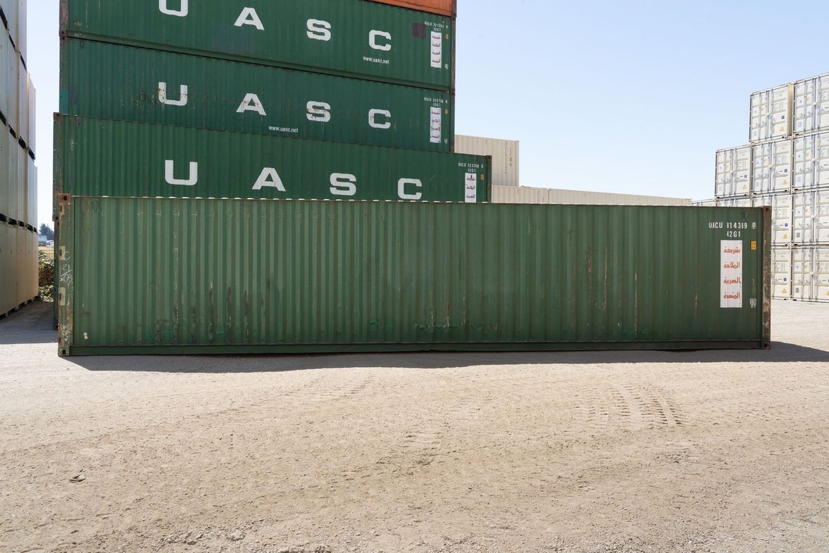 40ft Used Shipping Container – Standard Height, Storage Grade – side view of weathered green container in storage yard