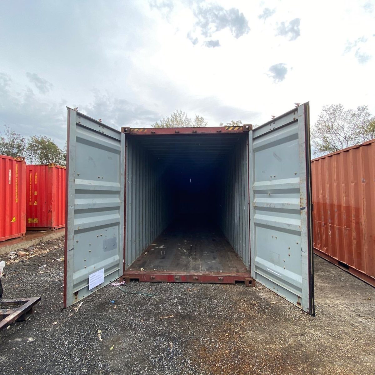 40ft Used Shipping Container – Lockable Double Cargo Doors – open cargo doors revealing a dark empty container interior