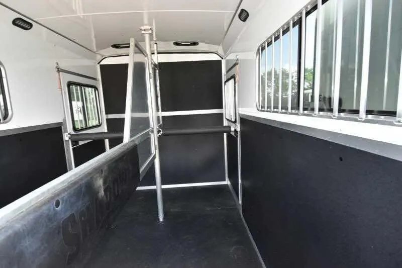 2016 Shadow 2 Horse Trailer – Aluminum, Dressing Room – Interior horse area with dividers, black padded walls, and bright white ceiling
