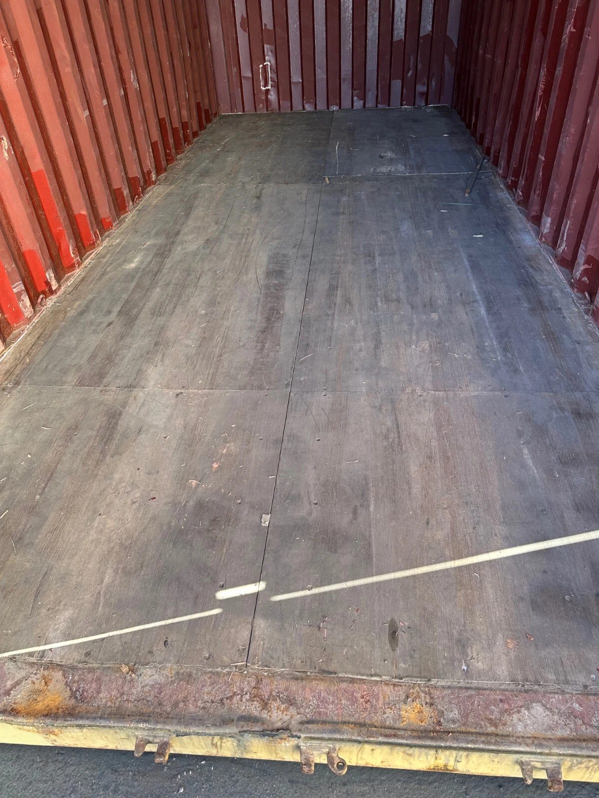 20ft Used Shipping Container – Yellow/Gold, Double Cargo Doors – empty container interior with worn wooden floor and red walls