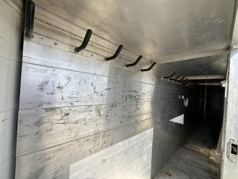 2005 Jamco 4 Horse Gooseneck Trailer – Blue, Air Suspension – Interior wall of the tack room with multiple bridle hooks