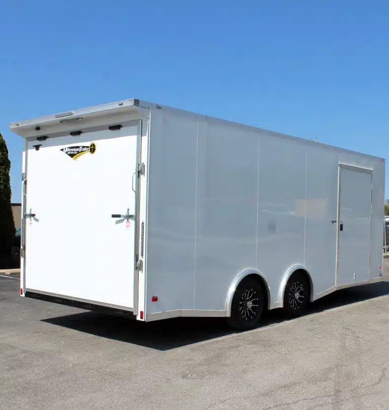 2025 Millennium Blaze 20 ft Enclosed Car Hauler – White – Rear three-quarter view of a white car hauler showing the rear ramp door