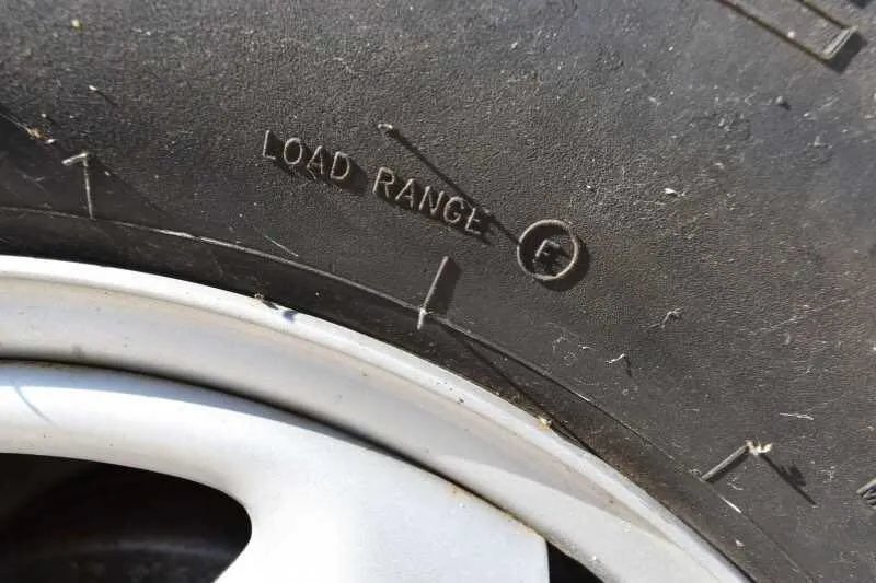 2010 Calico 2 Horse Trailer – Steel, Walk-In Dressing Room – Close-up shot of the tire sidewall showing the load range F rating text