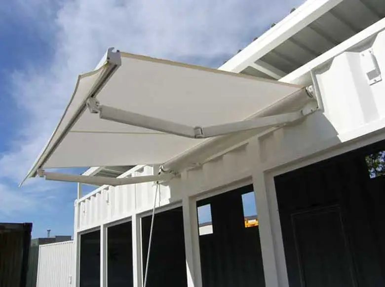 20 ft Switch Room Container – Insulated Panels – Close up of a retractable white awning extended from the side of a white container