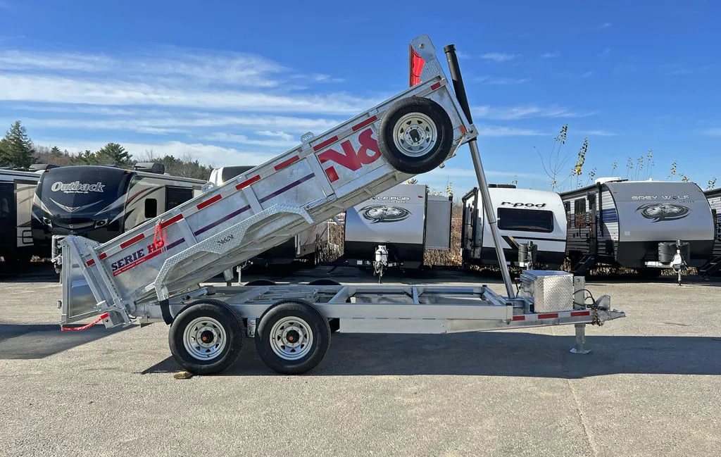 2024 N&N Trailers 14 ft Dump – Galvanized Steel – Low angle side view of the trailer with the bed tilted for dumping