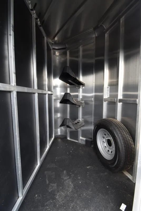 2021 Shadow 3 Horse Trailer – Fold-In Tack Wall – Front tack room area with saddle racks and a spare tire mounted