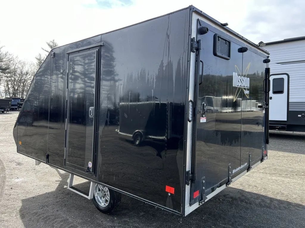 2021 Mission Trailers 2-Place Hybrid – Blackout Package – Rear three-quarter view from the left side showing the side door and ramp