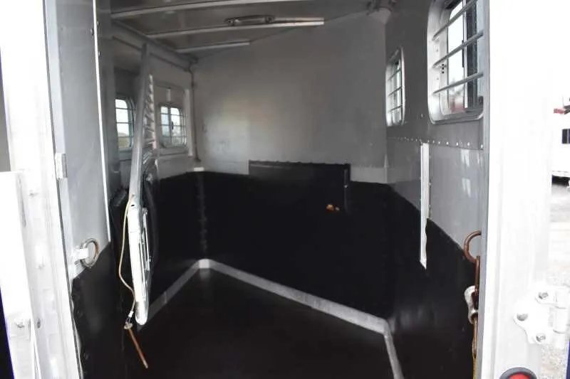 1995 Featherlite 2 Horse Trailer – Aluminum, Dressing Room – Empty horse stall area showing black kick mats and internal side windows