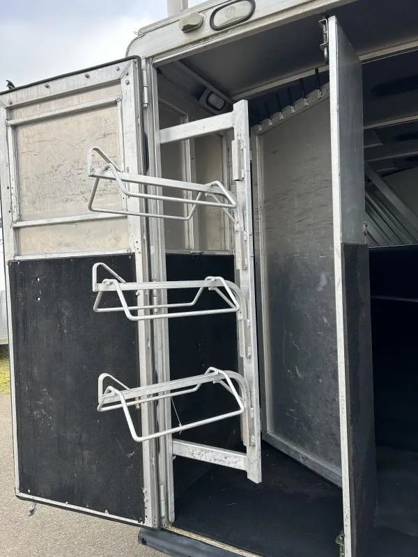 2002 Silverado 3 Horse Gooseneck Trailer – Wood Interior – Swing-out saddle rack mounted on the rear door frame of the trailer