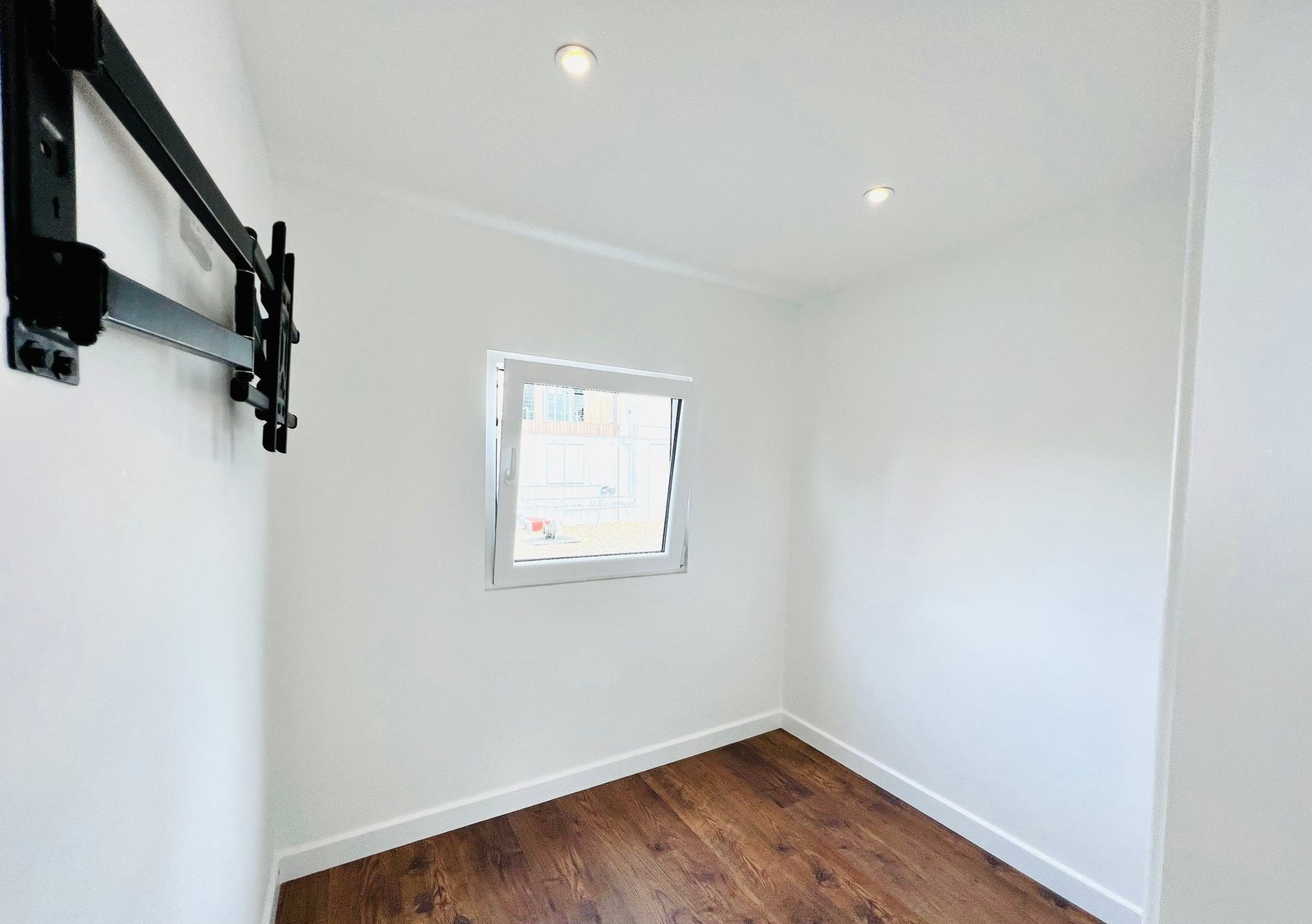 20ft Container Home – One Bed Box, 1 Bedroom – A modern one-bedroom shipping container annex featuring recessed lighting, insulated white walls, and durable wood-laminate flooring