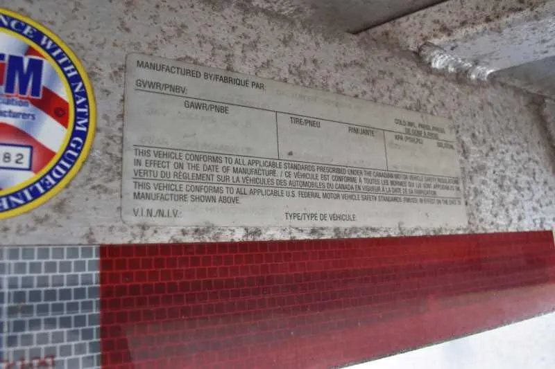 2006 Adam 7302 3 Horse Trailer – Aluminum, Dressing Room – Close-up of the manufacturer identification and VIN plate on the trailer frame