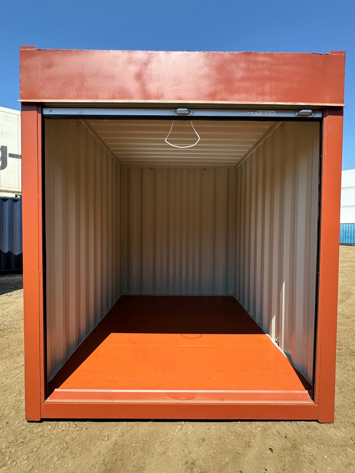 10ft Non-ISO Storage Container – Roll-Up Door – front view with raised roll-up door and empty interior