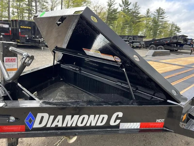 2024 Diamond C 24 ft Tilt Trailer – Spare Mount – Opened metal storage toolbox integrated into the front of the trailer frame